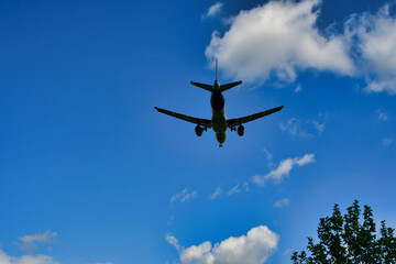 jet landing on Frankfurt Airport blue sky clouds