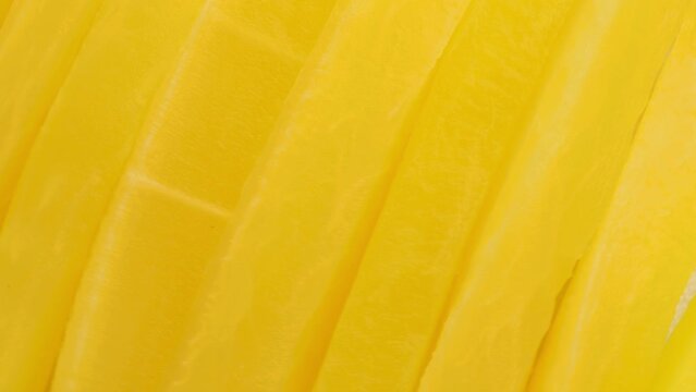 Bright yellow pickled Radish, rotation in circle. Pickled daikon bars, Turning. Japanese cuisine.