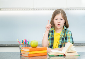 Surprised young girl reads the book and has idea. Success, idea and creative concept