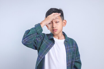 Little Boy Touching Head Having Headache and Problems Isolated on Grey Background