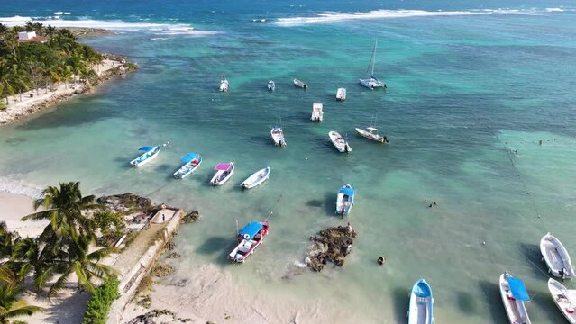 Beautiful drone shot of Akumal Bay with its crystal clear waters and tall palm trees