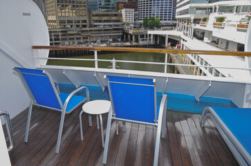Private terrace patio balcony veranda of suite stateroom cabin with deck chairs, sun loungers and whirlpool bath onboard cruiseship cruise ship ocean liner
