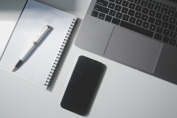 Top view of computer desk with keyboard, smartphone, stationery and coffee cup, clipping path