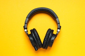 Over-ear, black headphones, on a dark background.