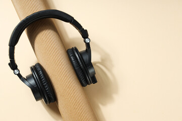 Over-ear, black headphones, on a dark background.