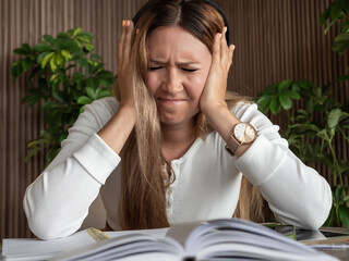 Adult woman with ADHD or dyslexia experiencing frustration and stress, sitting at desk with open...
