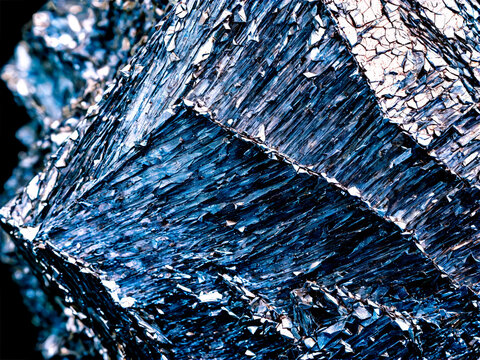 Phyllite A shiny phyllite with a crinkled surface and silvery sheen suspended to show its