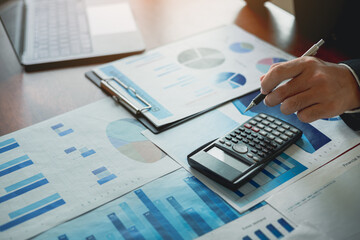 Businessman calculate a financial documents is analyzing historical finan data to plan investments value for money, savings, income, retirement, compensation funds, dividend taxes, savings, trading.