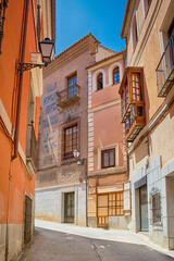 Spain Travel Ideas. Summer Streets of Toledo City in Spain Alleyway Towards Toledo Cathedral Alcazar in The Afternoon.