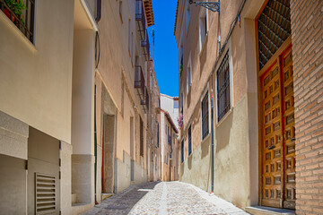 Travel Ideas. Summer Streets of Toledo City in Spain Alleyway Towards Toledo Cathedral Alcazar in...