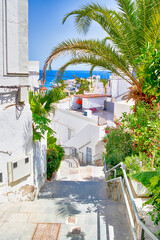 Scenic Sunny Summer Street With Bougainvillea Flowers in Puerto Mogan at Gran Canaria, Canary islands in Spain.