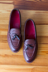 Closeup Upper View of Pair of Traditional Formal Stylish Brown Pebble Grain Tassel Loafer Shoes