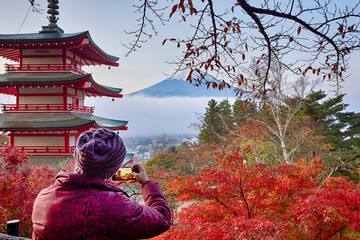 Asian Travel Routes. One Young Japanese Female Taking Pictures of Mt. Fuji Viewed From Behind...