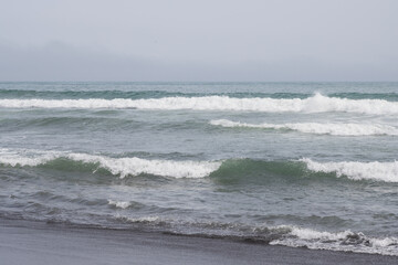 Seascape. View of the waves and surf. Windy weather. Waves, foam and ripples on the surface of sea...