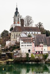 the clock is at the top of this building next to a lake