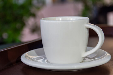 Close-up cup of espresso on the wooden table.