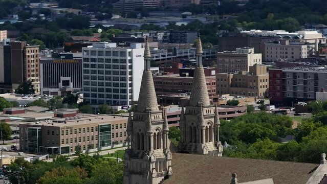 Circling an old Cathedral with a busy cityscape in the background
