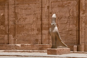 Stone statue of the bird representing Horus at the entrance to the temple of Edfu in Egypt.