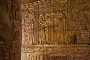 Interior of the temple of Edfu with Egyptian hieroglyphs carved on the walls and columns.