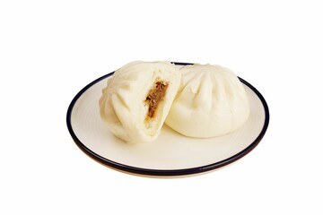 two asian steamed buns on a plate on a white table