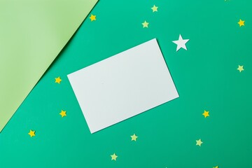 blank white card on green background with yellow stars