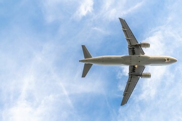 a large air plane flying through a cloudy sky covered in clouds