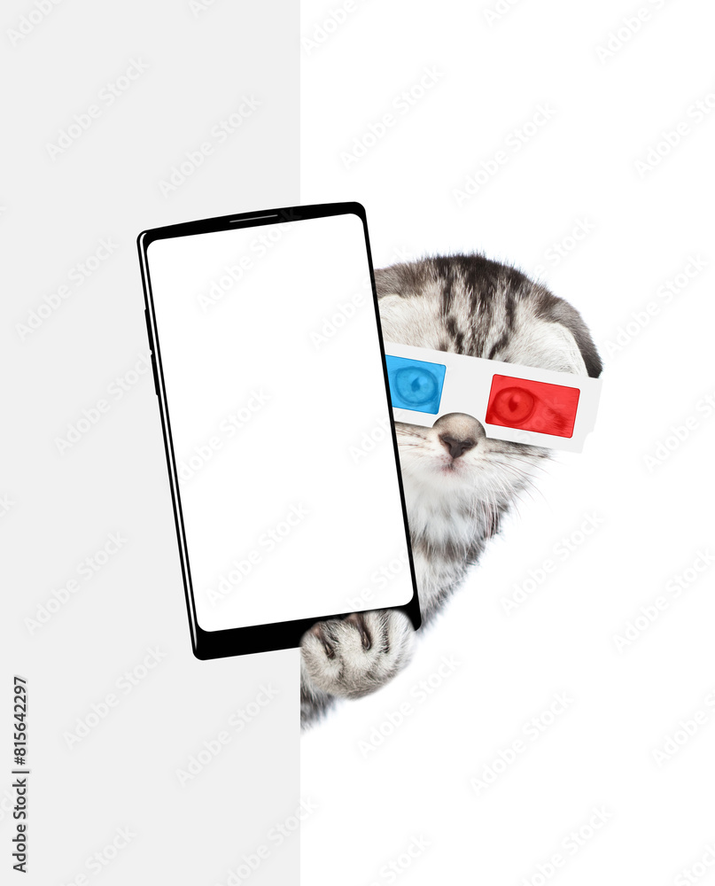 Poster cute tabby kitten wearing 3d glasses holds big smartphone with white blank screen in it paw, showing