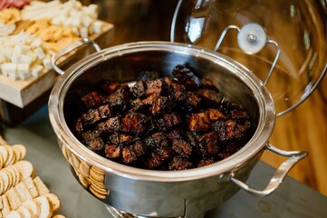 Close-up of a pan containing succulent pork belly, cooked to perfection