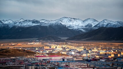 Fototapeta premium Tibetan Buddhist temple nestled in the snow-covered mountains of Qinghai Province, China.