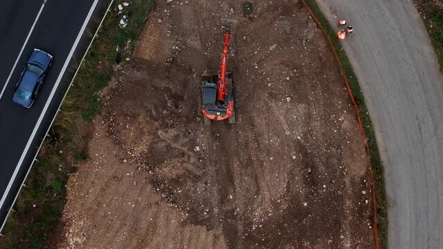 Bulldozer or excavator moving soil for a drainage canal.