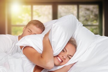 young woman sleep with boyfriends snoring at bed