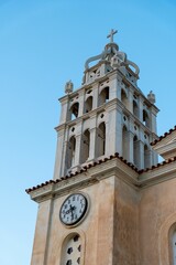 High-rise building standing out against the sky, featuring a clock at the top of its facade