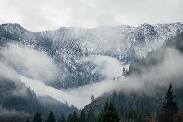 North Cascade mountain range in Northern Washington State, with light morning fog.