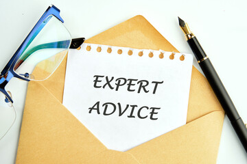 EXPERT ADVICE message an inscription on a piece of paper peeking out of an envelope next to glasses...