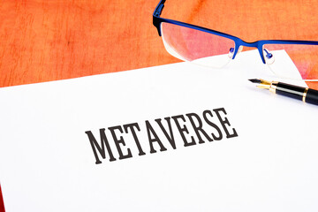 Metaverse concept an inscription on a white sheet on the table near glasses and a fountain pen