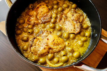 Delicious Mediterranean Chicken Thighs with Lemon and Green Olives Close Up 