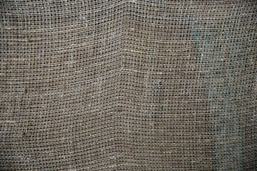 a dark colored cloth texture or background made with burlock and string
