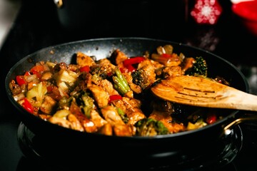 Close-up of vegetables and chicken fried in a pan