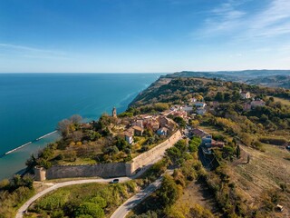 Aerial view of the small medieval village of Fiorenzuola di Focara immersed in the San Bartolo Park