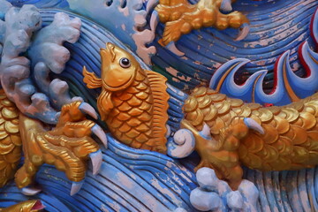 Wood Carving of Fish in Water.