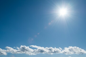 Sun radiating in the beautiful blue sky, creating a perfect backdrop to any project