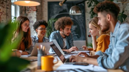 A lively team gathers around a laptop, engaging in a collaborative discussion in a well-lit, modern office setting. AIG41