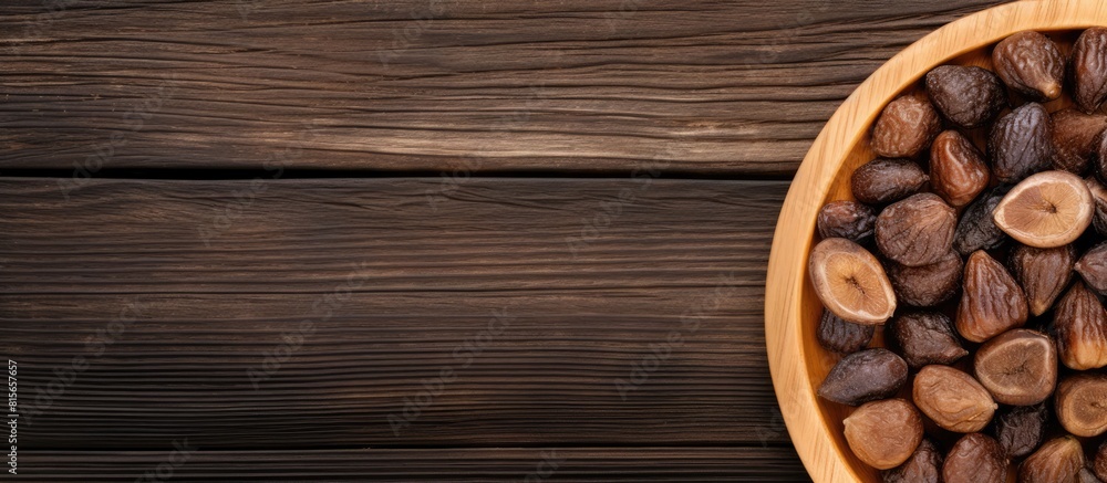 Poster bowl with tasty dried figs on wooden table top view space for text. copy space available