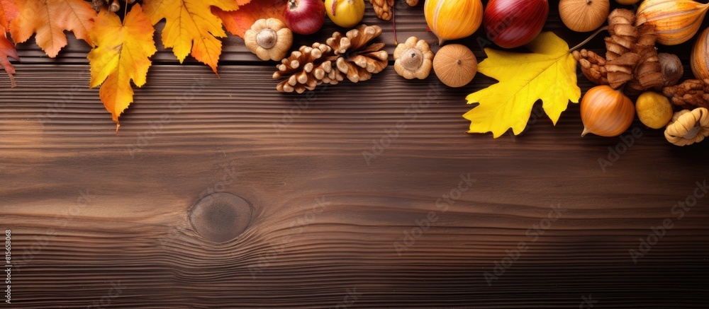 Poster autumn still life with yellow leaves nuts on a wooden background view from above. copy space availab