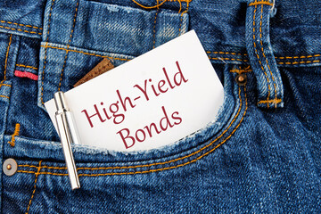 Inscription High-Yield Bonds on a business card peeking out of a jeans pocket