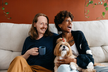 Relaxed couple enjoying a cozy moment with their dog at home