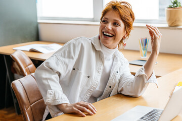 Joyful freelancer in vibrant co-working office space