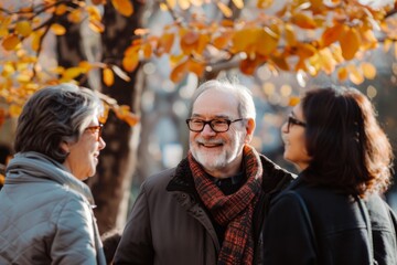 Portrait of a senior man with his family in the autumn park.