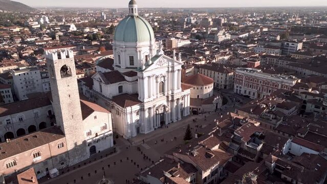 Ascending drone shot of Cathedral of Santa Maria Assunta and Pegol Tower in Brescia, Lombardy, Italy