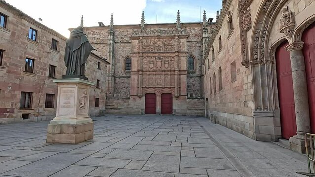 Walking towards the facade of the historic University of Salamanca with the sculpture of Fray Luis de Leon. The oldest university in Spain and Europe